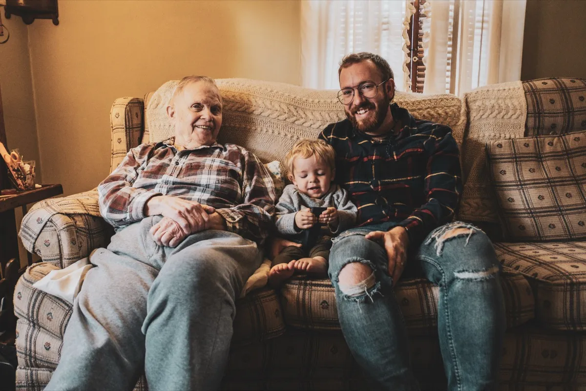Three generations of a family together on their sofa